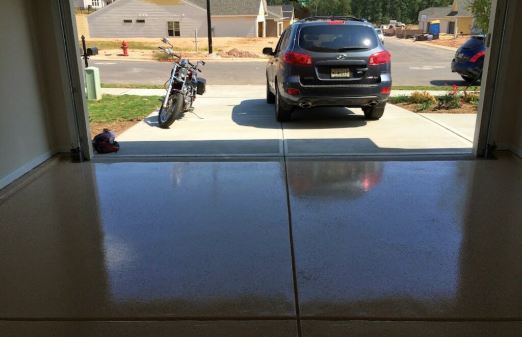 A garage with a car and a motorcycle