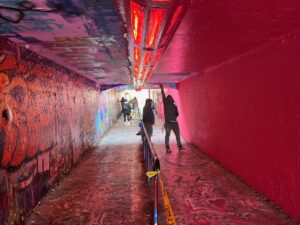 A concrete tunnel filled with graffiti